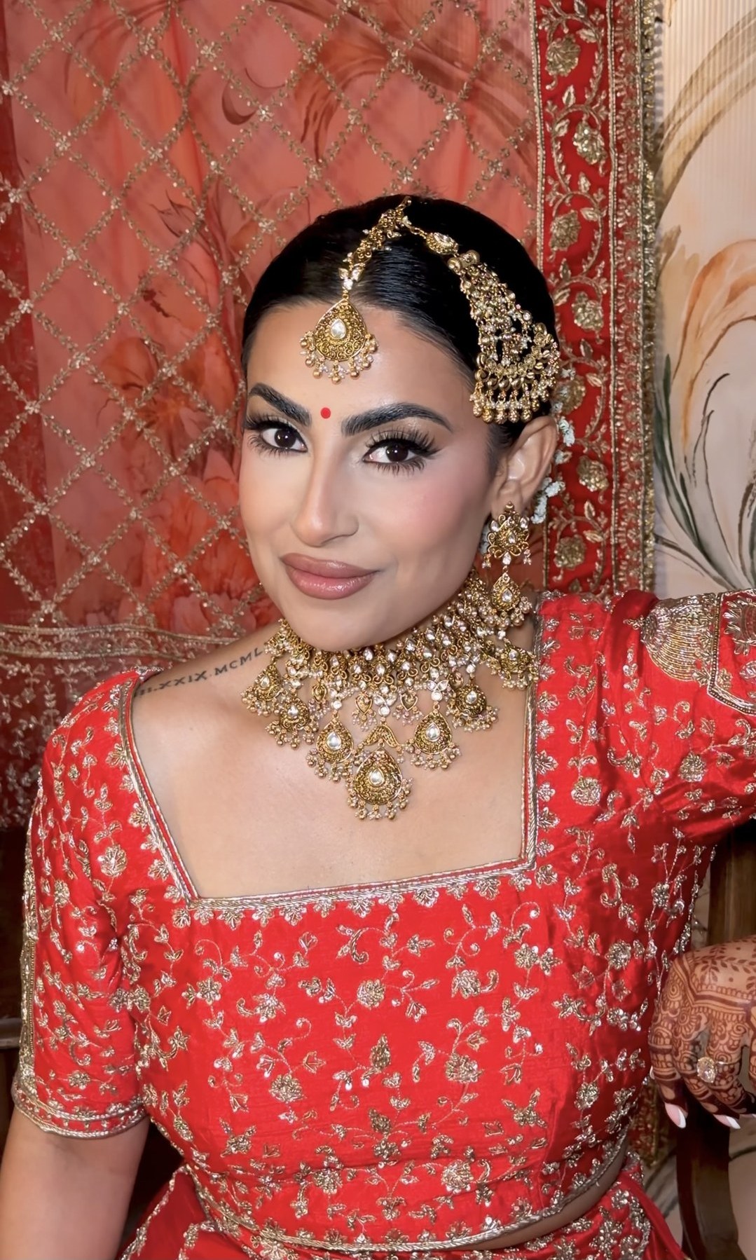 Bridal look — red lehenga with gold jewelry