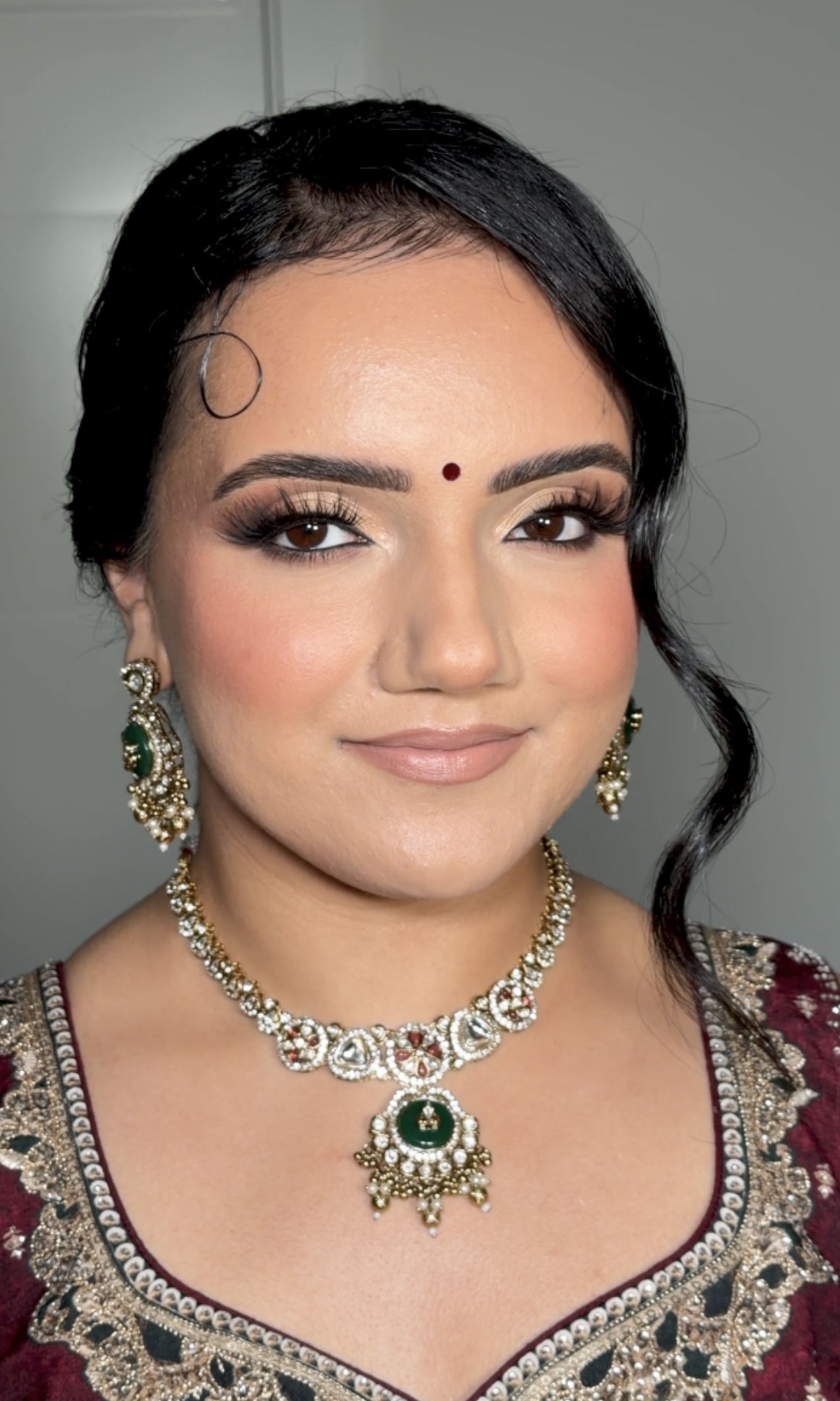 Bridal look — maroon outfit with emerald jewelry set