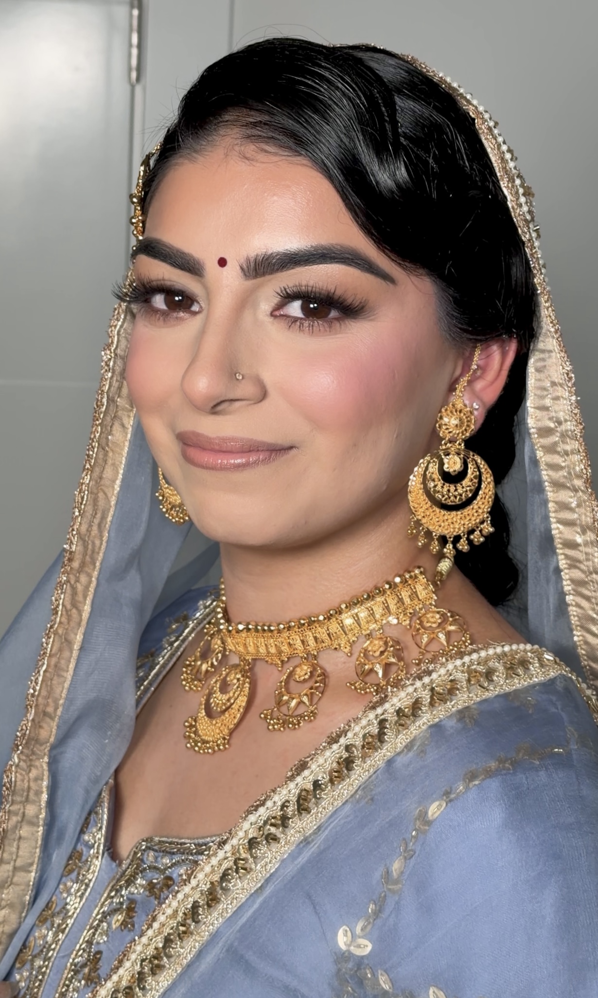 Bridal look — dusty blue dupatta with gold jewelry